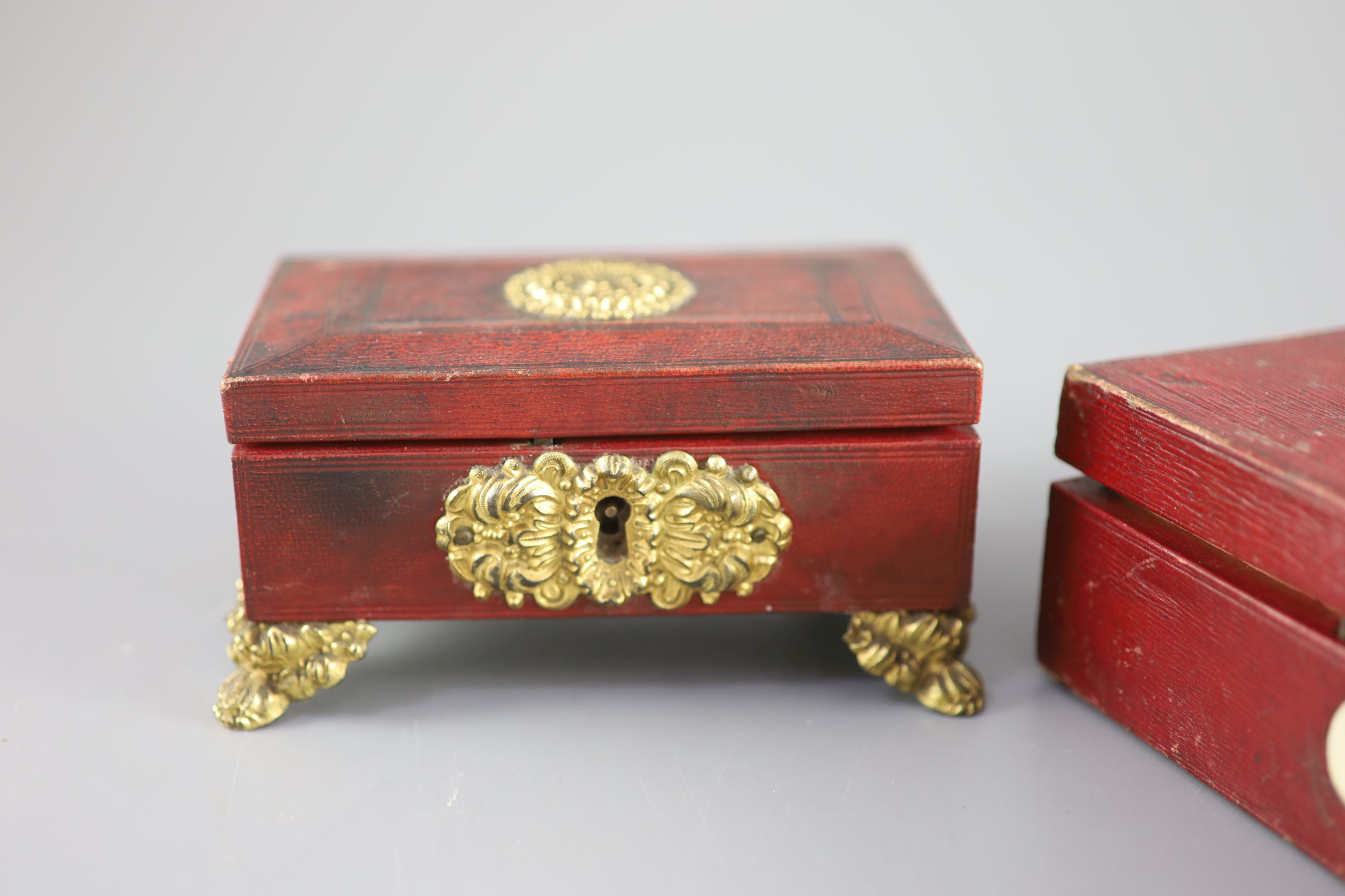 Two early 19th century red leather work boxes with assorted fittings